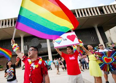 Hawaii man holding rainbow flag